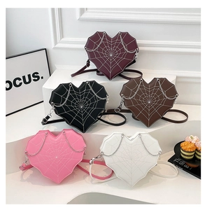 Selection of heart-shaped crossbody bags featuring spider web stitching and metal chains