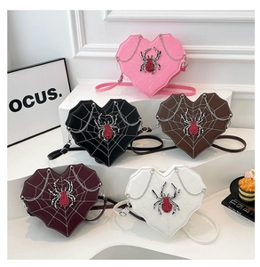 Detail of gothic heart crossbody bags with spider web texture and rhinestone accents