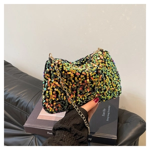 Detail of colorful sequins and gold chain strap on a shimmering evening shoulder bag