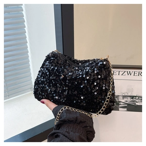 Close-up of black sequin shoulder bag featuring shiny texture and gold chain strap detail