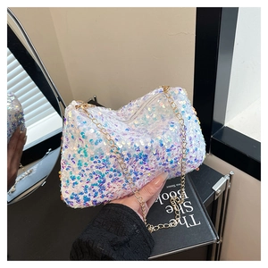 Detailed shot of white iridescent sequins on a crescent bag with gold chain strap