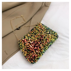 Detailed macro view of colorful shimmering sequins and gold chain strap on small crossbody bag