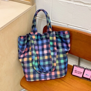 Colorful checkered wool tote bag on wooden bench featuring large capacity and dual straps