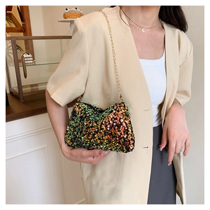 Detail of colorful sequin chain bag showing gradient glitter finish and gold strap