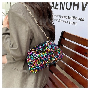 Detail of colorful sequins handbag with gold chain strap on olive green blazer