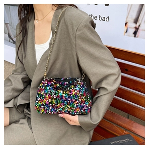 Detail of colorful sequins on a stylish crossbody bag with a gold metal chain strap