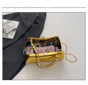 Top view of gold acrylic box bag showing interior capacity for phone and cosmetics