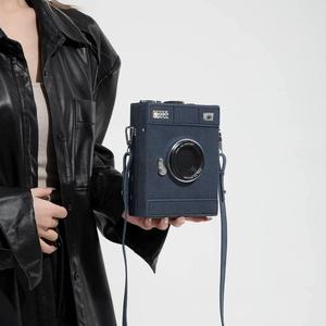 Retro camera-shaped crossbody bag in navy blue with a stylish adjustable strap