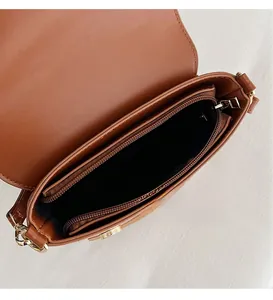 Detail view of the brown leather owl bucket bag featuring an organized inner compartment