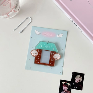 Detail of house-shaped acrylic photo card holder with wings and mint green roof accents