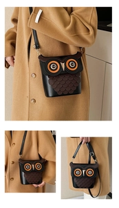 Detailed view of the creative owl crossbody bag featuring unique feather texture and golden beak