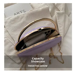 Internal capacity display of purple oval evening bag holding a smartphone and wallet