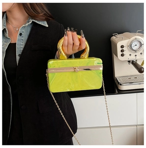 Detail of neon marble acrylic handbag with chunky gold metal handle and chain strap