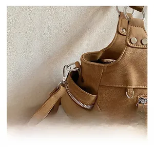 Detail shot of brown vintage leather tote with silver metal hooks and buckle studs