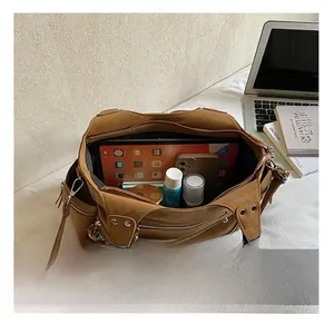 Detail view of large brown tote bag interior storage capacity for tablet and cosmetics