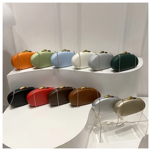 Array of colorful oval evening clutch bags with metallic ball clasps and chain straps