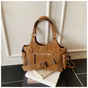Macro view of vintage brown motorcycle tote bag with metallic zippers and buckle detail