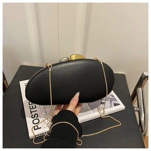 Detailed shot of an oval PU leather evening bag with two-tone metal pebble clasp