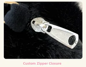 Macro shot of custom silver metal zipper on black plush backpack showing hardware texture