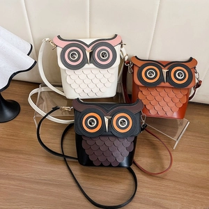 Creative owl-shaped bucket bags in black, brown, and white with layered scale feathers