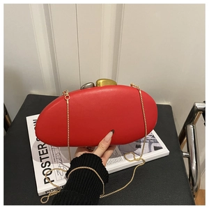 Detailed view of red pebble-shaped clutch bag with unique gold and silver stone clasp