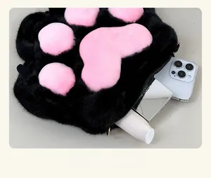 Detailed interior view showing large capacity for phone and makeup in plush cat paw bag