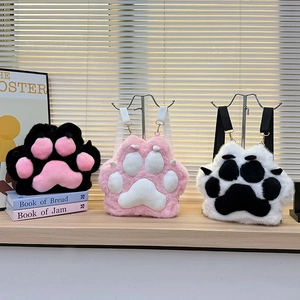 Detailed view of three plush cat paw backpacks with soft faux fur and adjustable straps