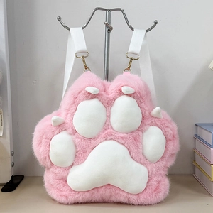 Detail of pink plush cat paw bag with soft faux fur texture and gold metal hardware clips