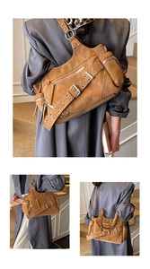 Detail of vintage brown leather tote with decorative studs, zippers and multi-pocket design