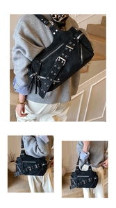 Detailed view of black rivets bucket bag with silver metal eyelets and multiple zippers