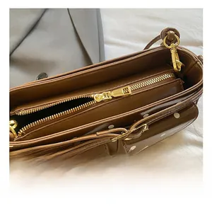 Détail des ferrures dorées et de la fermeture éclair sur le sac vintage à pois