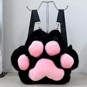Detailed view of plush cat paw backpack featuring soft black fur and pink 3D paw pads
