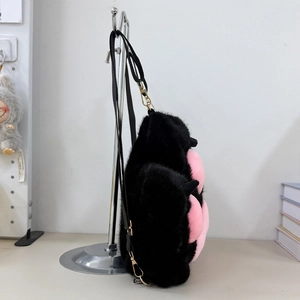 Side view of plush cat paw backpack with black and pink faux fur and detachable strap