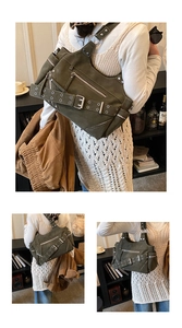 Detail of vintage biker tote bag showing silver grommets and textured olive faux leather