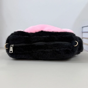 Top view of plush cat paw bag with black fur, pink trim and golden metal D-rings