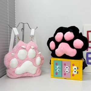 Detail view of pink and black plush cat paw backpacks with soft fur and 3D paw pads