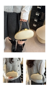Detail of oval gold acrylic clutch bag with metallic finish and delicate chain strap