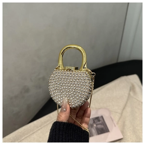 Detail of silver heart shaped mini bag featuring rivet studs and gold padlock handle