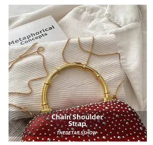 Detail of red rhinestone evening bag with gold bamboo handle and metal chain strap
