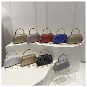 Close-up of luxury rhinestone evening bags with bamboo handles in nine various colors