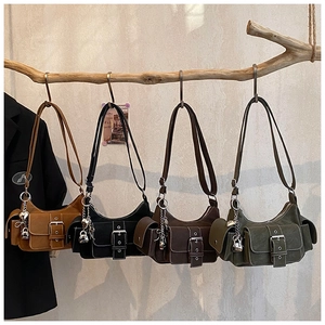 Multi-color utility tote bags in faux suede hanging on wood branch for display