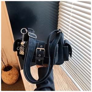 Detail of vintage black suede tote with white contrast stitching and heart charms