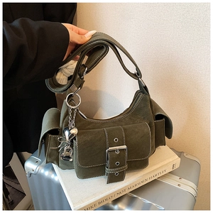 Detail of olive green cargo shoulder bag with multiple pockets and silver heart charm