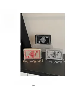 Three rhinestone poker card evening bags in black, gold, and silver with chain straps