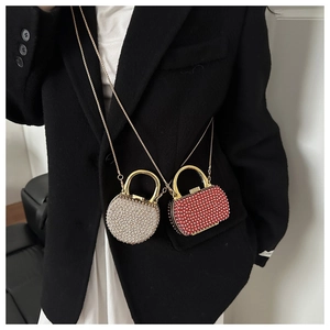 Detail of mini rhinestone dinner bags with gold metal chains and hard acrylic shells
