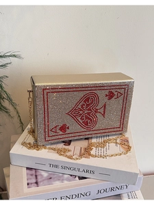 Macro shot of Ace of Spades rhinestone clutch bag with gold chain and sparkling crystals