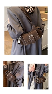 Detail of dark brown suede shoulder bag featuring contrast stitching and multiple pockets