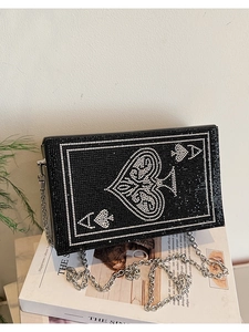 Detail of Ace of Spades evening bag featuring sparkling rhinestones and silver chain