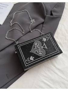 Close-up of Ace of Spades rhinestone clutch bag with elegant silver chain strap
