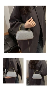 Detail of silver rhinestone evening bag with gold bamboo handle and chain strap